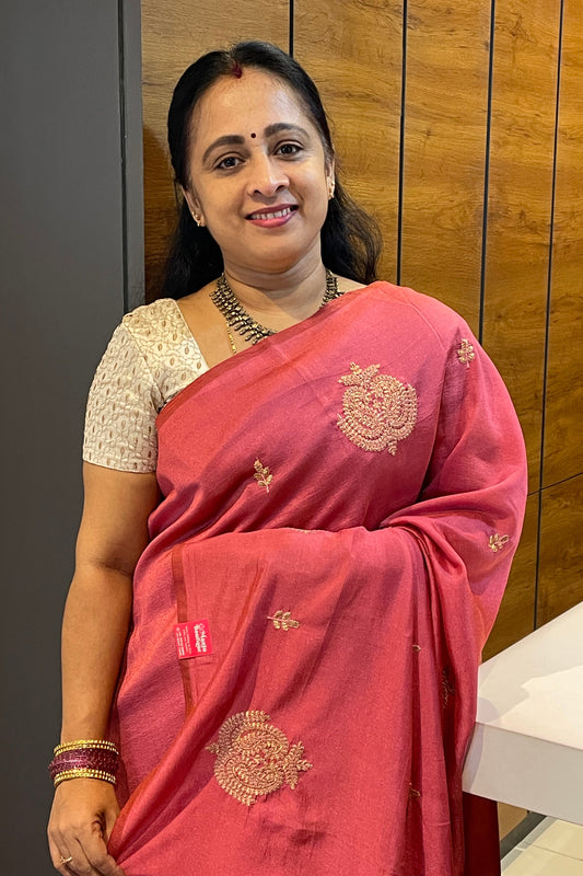Onion Pink Malai Silk Saree with intricate embroidery, draped elegantly, paired with a rich cream embroidered blouse